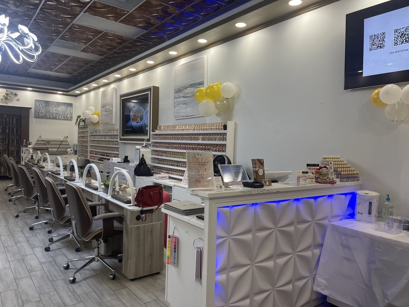 Manicure tables, polish wall and reception at Vivid Nails