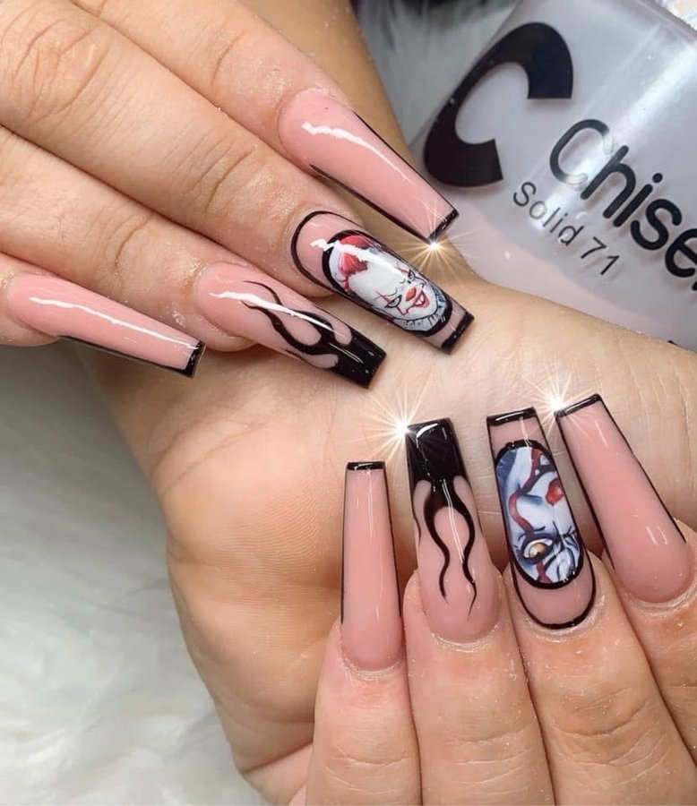 Hand-painted clown portrait nail art with flames